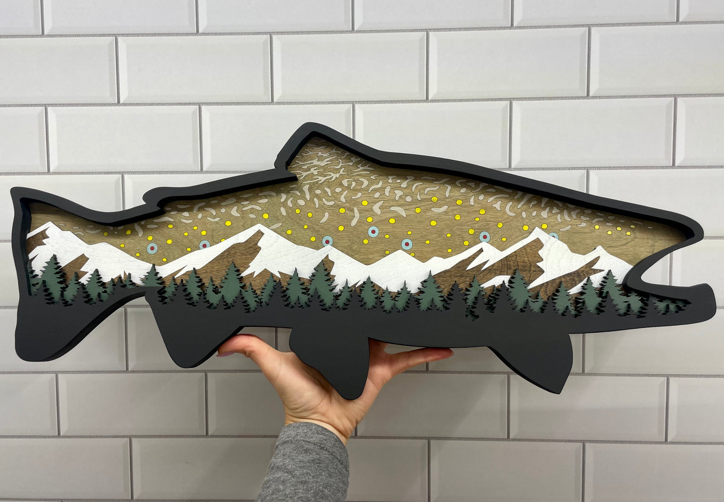 24" Brook Trout wood art with hand for size reference.
