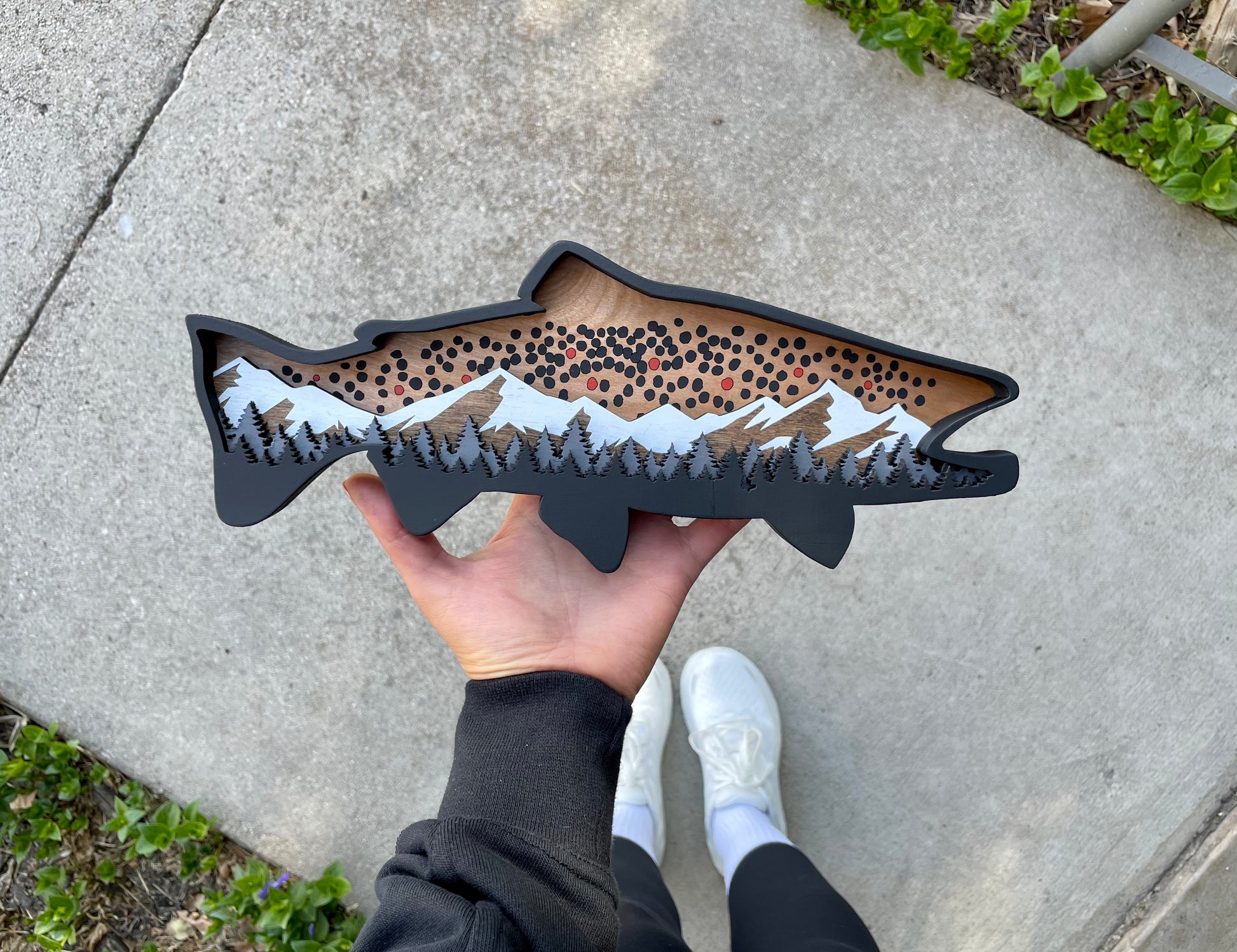 12" Brown Trout wood art with hand for size reference.